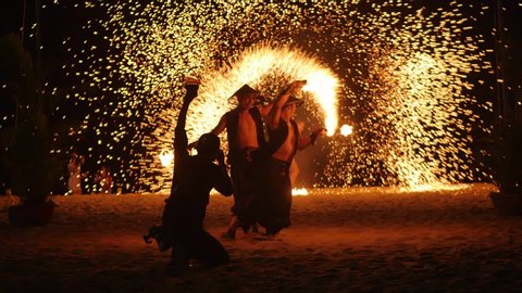 Fire show. Group of professional artists performs a variety of fire facilities. Boys and girls performed dances with fire in the night on the street in Park. Vietnam, Nha Trang - February 9,2020