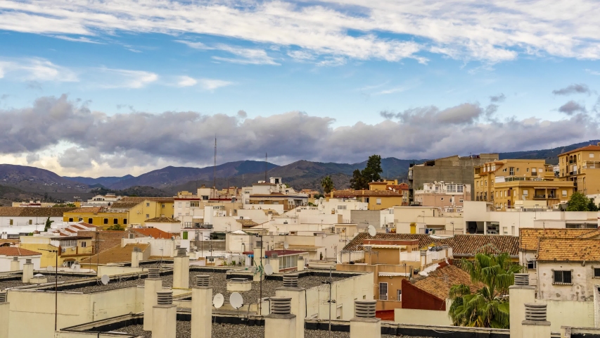 Timelapse - sunny day blue sky, clouds over city Malaga, Spain