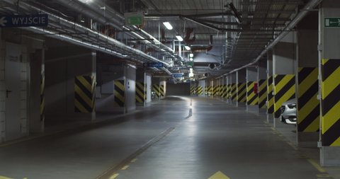 Underground parking space, industrial interior, parking lanes. Underground garage or modern car parking, Reveal shot, color toned.