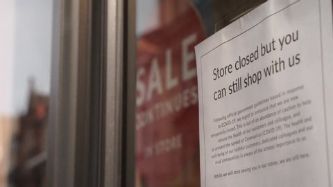 Manchester, England / UK - April 11 2020: store closed sign in a shop window in Manchester city centre during lockdown for the coronavirus covid-19 pandemic 