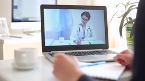 A female doctor consults an online patient. Medical videoconferencing advisory.