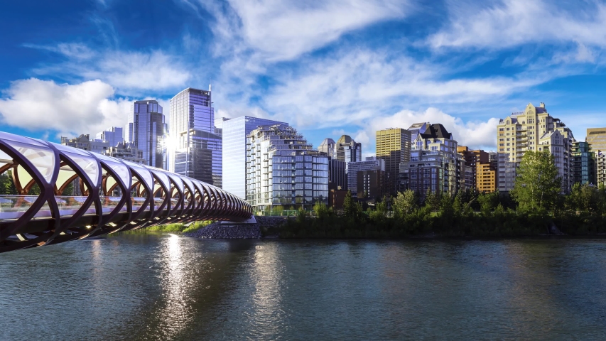 Cinemagraph Continuous Loop Animation. Peace Bridge across Bow River with Modern City Buildings in Background during a vibrant summer sunrise. Taken in Calgary, Alberta, Canada.