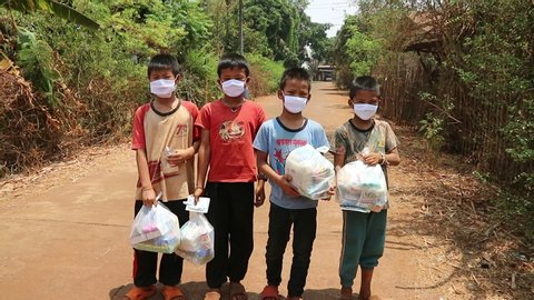 Children and people have been rescued. Put on a protective mask of Covid-19 At Phop Phra District, Tak Province, Thailand on 11.4.2020 at 14:00 hrs.