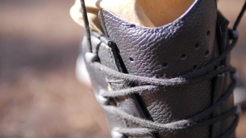 Close up of the laces on a leather military boot being tightened so the boot squeezes in before being tied Royalty-Free Stock Footage #1050295552
