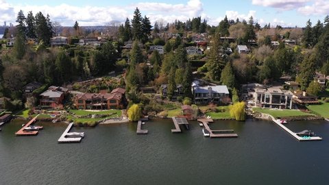 Aerial / drone footage of Meydenbauer Bay, beach park, marinas with waterfront mansions in Belleview near Seattle, Washington during the COVID-19 pandemic