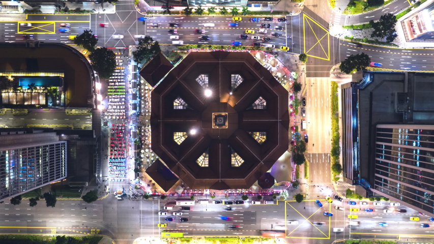 4K time-lapse of car traffic transport at square junction road intersection in Singapore city downtown district, drone aerial top view zoom out. Transportation technology, Asian city life, Asia travel