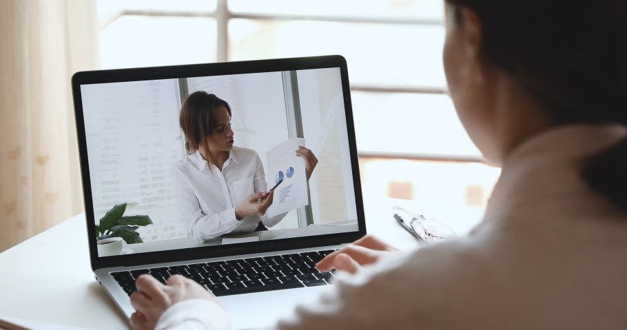 Businesswoman executive doing financial report presentation consulting distance client, remote worker, making video conference business call. Work from home webcam chat concept. Over shoulder view Royalty-Free Stock Footage #1050326371