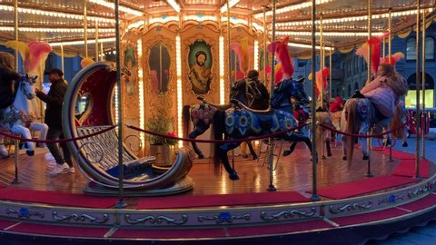 FLORENCE, ITALY - JANUARY 26, 2020.  Flashing light of vintage carousel carnival fair merry go round circus horse ride at amusement park Florence, Tuscany, Italy. 