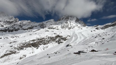 4k Timelapse of Matterhorn swiss alps mountain range in Cervinia ski resort, Italy, Europe, panning panorama
