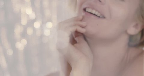 Close up of sexy woman posing for beauty fashion concept in front of out of focus sparkle shimmer curtain background glamorous model moving in slow motion shot in 6K on RED EPIC DRAGON