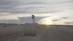 Girl in a light white dress in the field