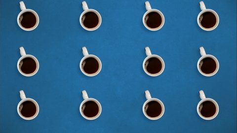 Top view. Stop motion. Coffee mugs rotating and fill with coffee. On blue background. Loop video. Concept of time coffee, energy, advertisement, power, systems. Cup of coffee 4k stock footages 