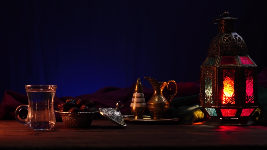 Ramadan Islamic Background. Fasting during the month of Ramadan dawn to sunset. Break Ramadan Fast. Iftar - Dates and a glass of water. Eid Mubarak. Arabic patterns lantern and tableware