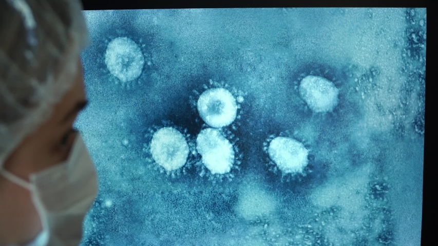 Close up of photo of virus under microscope on computer monitor screen on background of team of doctors. Scientists in laboratory discuss Coronavirus Royalty-Free Stock Footage #1050368692