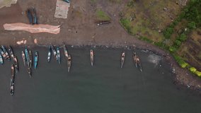 Flying over fishing boats at the Kenyan coast. Boat coming ashore, drone stock footage by DroneRune