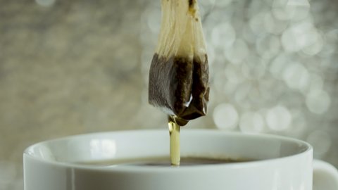 Tea bag in a white cup of tea. Making morning tea. Available in 4K and HD. This tea video clip is suitable for recipe and food projects. Download the preview for free here.