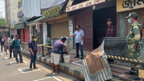 Guwahati, Assam, India. 13 April 2020.  People in queue to buy liquor as they are maintaining social distancing, during the nationwide lockdown to curb the spread of coronavirus, in Guwahati. 
