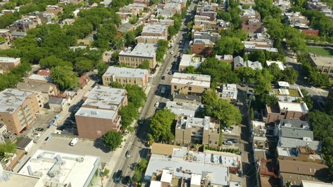 Aerial Tracking Shot of Cars Driving in Urban Neighborhood
