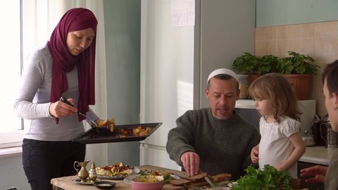 Ramadan Month. Arabic muslim family eating traditional Middle Eastern meals. The fast-breaking food at sunset