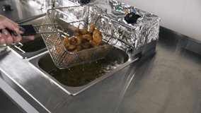 Process of cooking chicken Buffalo wings in the deep fryer