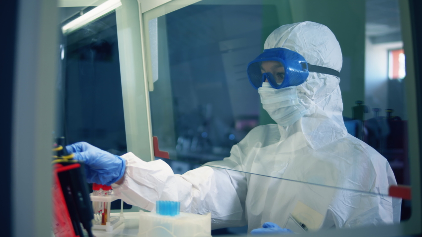 Female doctor work in laboratory, developing a vaccine. Coronavirus, COVID-19, 2019-ncov medicines research concept. | Shutterstock HD Video #1050442939