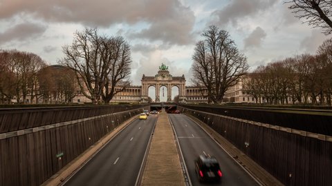 Brussels / Belgium - January 9 2019: Day to Night Time Lapse from Cinquantenaire Park tunnel in Brussels. Cars drive in the tunnel under the Arc de Triomphe Monument