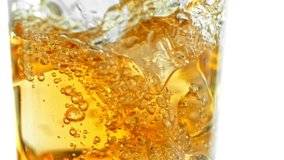 Super Slow Motion Shot of Pouring Ice Tea into Glass with Ice at 1000fps, Isolated on White Background. - Powered by Shutterstock - Get 15% off with code: PIKWIZARD15