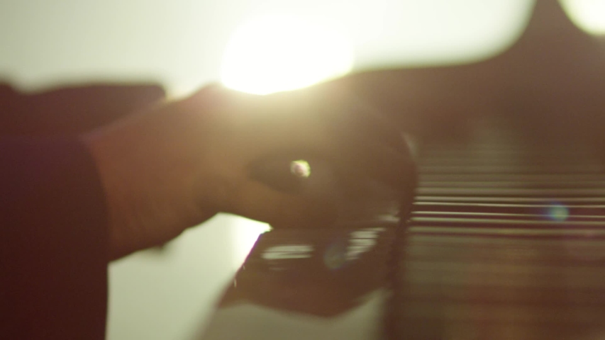 Footage of male hands playing grand piano . Man touches fingers on keys . Pianist plays in beautiful grand piano on stage in concert . Close up . Shot on ARRI ALEXA movie camera in slow motion . | Shutterstock HD Video #1050458698
