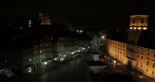 Aerial video showing the Old Town, Sigmund Column, Castle Square and Royal Castle in Warsaw at night. Baroque architecture of the building.