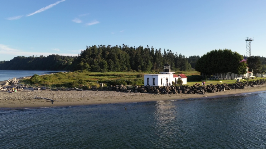 Drone footage of Point No Point Park, Puget Sound with the lighthouse in the background