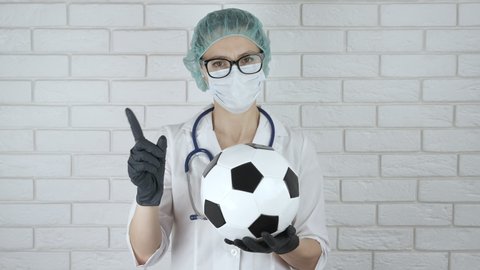 Postpone the game of football. A doctor in medical costume warns that football competitions should be suspended due to coronavirus epidemic.