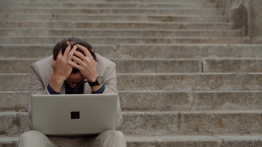 Tired Worker Overworked . Frustrated Businessman Sitting On Steps. Remote Work Overtime. Workaholic Work In Internet Deadline. Tired Businessman In City Street. Overwhelmed Exhausted Stressed Banker | Shutterstock HD Video #1050476500