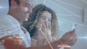 Animation of mixed race couple sitting on couch, using laptop and holding a credit card, high fiving over data processing and digital information flowing - Powered by Shutterstock - Get 15% off with code: PIKWIZARD15