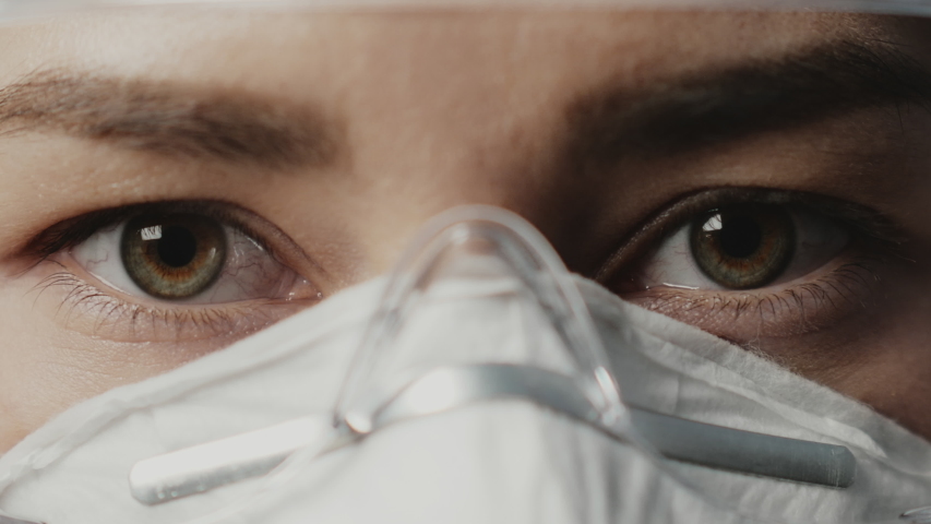 Portrait of confident doctor woman face, close-up. eyes with safety glasses and protective mask. Research Laboratory Officer. 2019 Novel Coronavirus (2019-nCoV), COVID-19, pandemic, isolation concept. Royalty-Free Stock Footage #1050499081