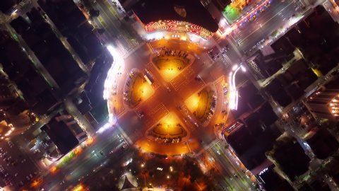 
Top down Hyper-lapse of the busy traffic at night across the circular intersection of Zhonghua Road & Wufu 3rd Road, which are two of the arterial avenues in Kaohsiung, a vibrant city in South Taiwan