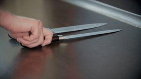 A person putting the knives on the kitchen stand one by one - Powered by Shutterstock - Get 15% off with code: PIKWIZARD15