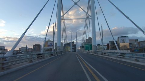 Johannesburg, South Africa - April 13, 2020: A tracking shot at dusk on an empty Nelson Mandela Bridge during the covid-19 coronavirus lockdown.