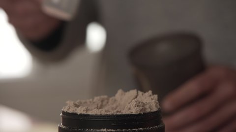 Serving A Portion Of Protein Powder Into The Shaker bottle