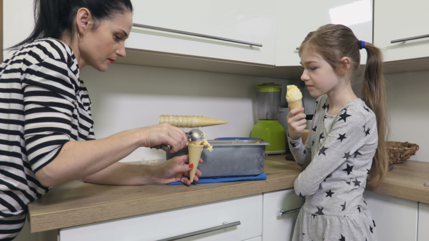 Family eating self made ice cream in kitchen
