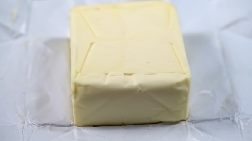 Homemade white butter in open packaging. Closeup.