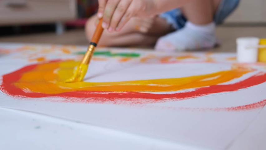 young diverse children paint colorful space pictures together on paper using paint brushes happy kids enjoying fun creativity painting science fiction space drawing pictures top view