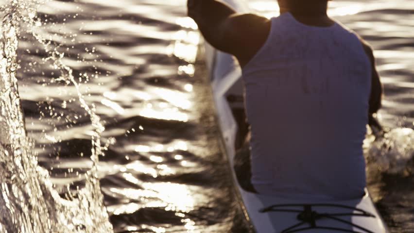 A man rowing in a kayak on the Brisbane River.