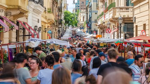 Buenos Aires, Argentina - January 05, 2020: Timelapse view of tourists and locals at the popular San Telmo Market in Buenos Aires, Argentina. 