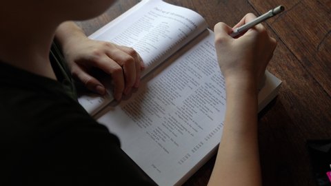 Bangkok, Thailand - April 12 , 2020 : Young person studying english grammar at home .