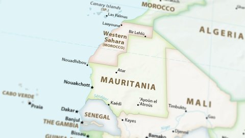Mauritania and Western Sahara on a political map of the world. Video defocuses showing and hiding the map (4K UHD).