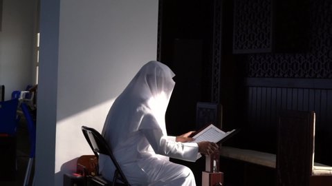 Dammam - Saudi Arabia 2019: An old man is reading Quran in mosque