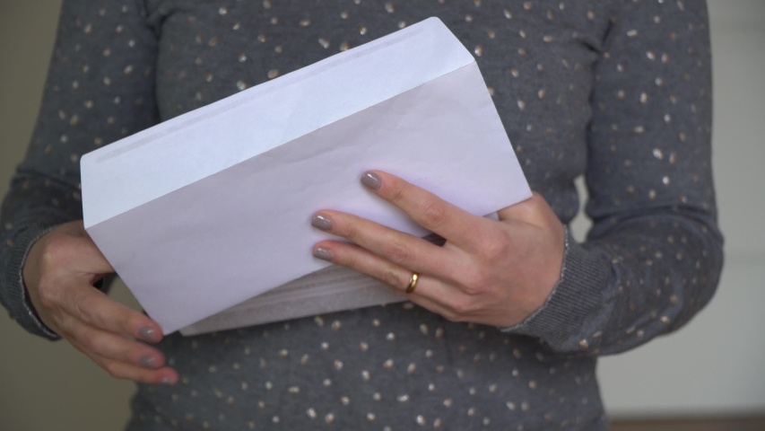 Woman reads received news holds documents paper letter feels desperate about financial problems, domestic bills or debt Royalty-Free Stock Footage #1050576115