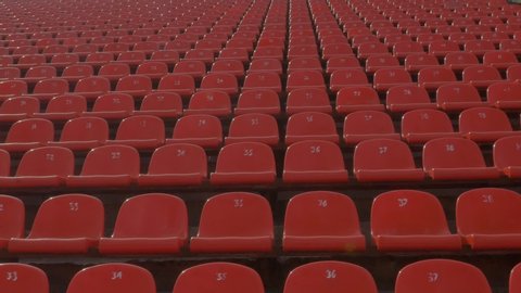 Panning of empty stadium seats, stadium without viewers.