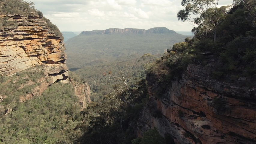 Panoramic Blue Mountains Australia. DRONE. Dramatic views of peaks, rock, valley, landscape, green rainforest jungle. Adventure, freedom, fun concepts. Tourist mountain trek. Shot in Sydney, NSW. Royalty-Free Stock Footage #1050583432