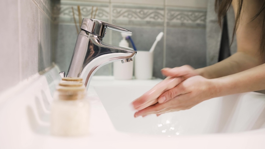 Antiseptic hand washing practice with soap and water in bathroom.Decontamination procedure,personal hygiene routine.Cleaning hands regularly.Infectious disease prevention/protection.Clean hands | Shutterstock HD Video #1050585991